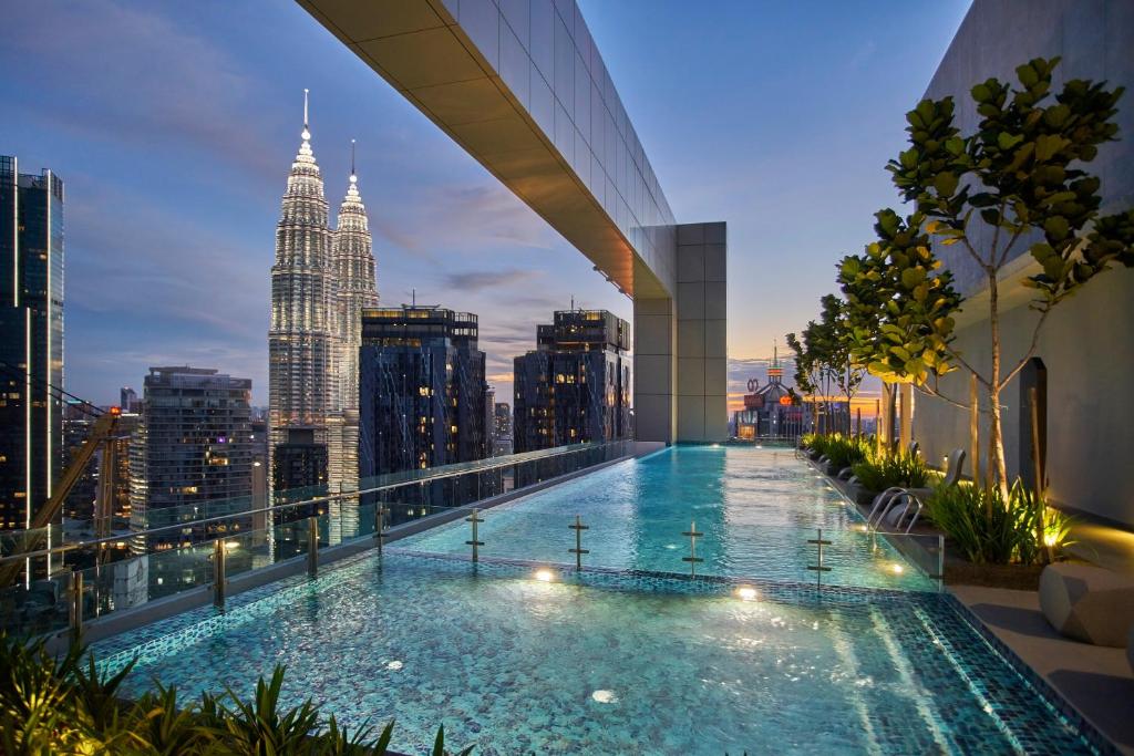 Vista de la piscina infinita en Royce KLCC con las Petronas de fondo, un lujoso edificio en el centro de Kuala Lumpur.