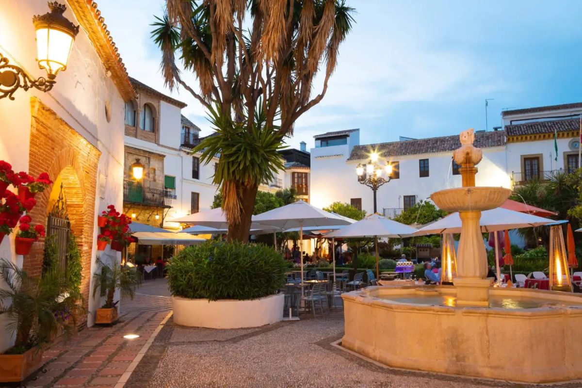 Vista del casco antiguo de Marbella iluminado por la luz del atardecer, destacando su arquitectura andaluza.