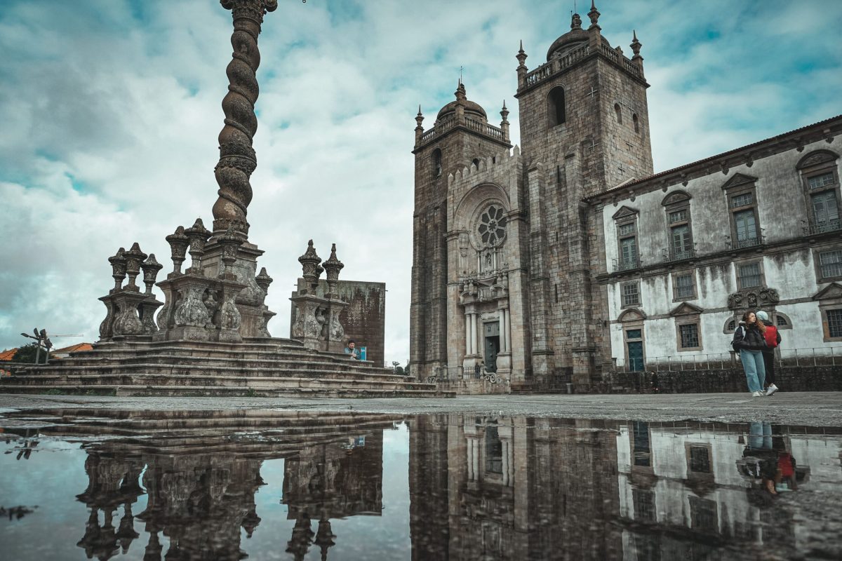 Catedral de Oporto bajo la Lluvia: Reflejos Mágicos Catedral de Oporto en un día lluvioso con reflejo en un charco